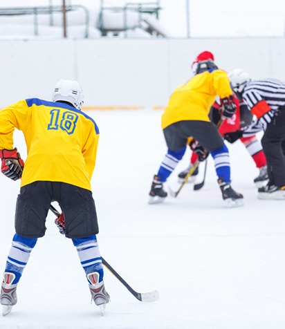 Referee Starting Ice Hockey Game Throwing In The Puck On The Rink Referee Starting Ice Hockey Game Throwing In The Puck On The Rink